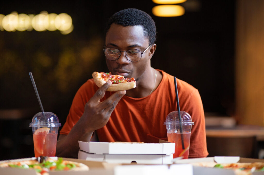 hungry man eating pizza
